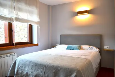 Cama o camas de una habitación en Apartament rústic amb llar de foc by RURAL D'ÀNEU