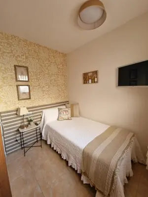 Cama o camas de una habitación en Apartahotel La Chipranera