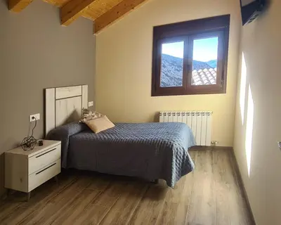 Cama o camas de una habitación en Apartamentos La Era de Pasé