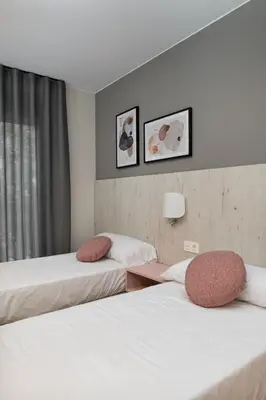 Cama o camas de una habitación en Apartamentos Torre del Reloj