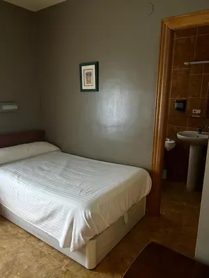 Cama o camas de una habitación en Hostal El Corzo