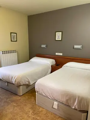 Cama o camas de una habitación en Hostal El Corzo