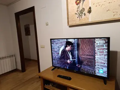 Una televisión o centro de entretenimiento en InmoCyma Verdiblanco Familias-Valle de Benasque