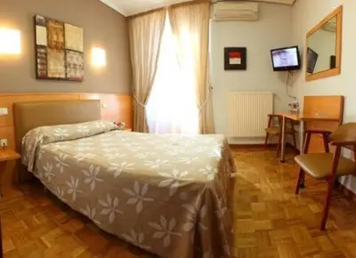 Cama o camas de una habitación en Hostal Arotza