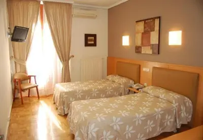 Cama o camas de una habitación en Hostal Arotza