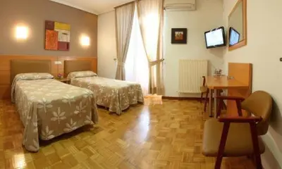 Cama o camas de una habitación en Hostal Arotza