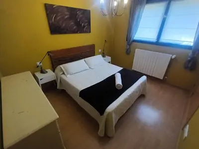 Cama o camas de una habitación en Camino Santiago Etxea
