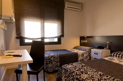 Cama o camas de una habitación en Hostal Plaza
