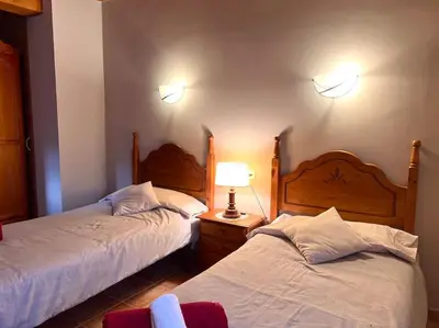 Cama o camas de una habitación en Casa Martinach - L'Amfitriona