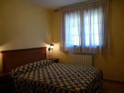 Cama o camas de una habitación en Complejo Turístico Bielsa Hotel y camping