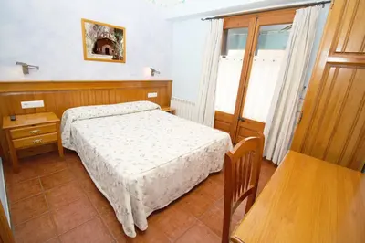 Cama o camas de una habitación en EVA & TRAVEL - Hotel LA BOTIGA