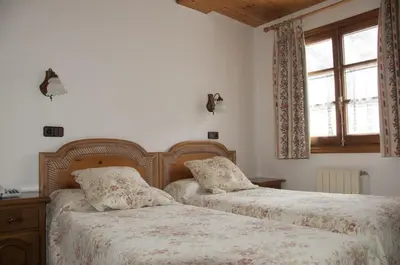 Cama o camas de una habitación en San Marsial Benasque Apart Hotel