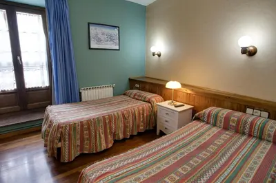 Cama o camas de una habitación en Hotel Avenida Benasque