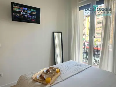 Cama o camas de una habitación en Dos Torres La Dulcería - Jacuzzi y vistas en el corazón de Zaragoza