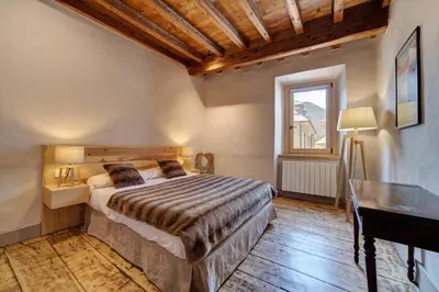 Cama o camas de una habitación en Casa Montlude - Elegancia rústica y confort moderno en el corazón del Valle de Arán by Eth Flòc
