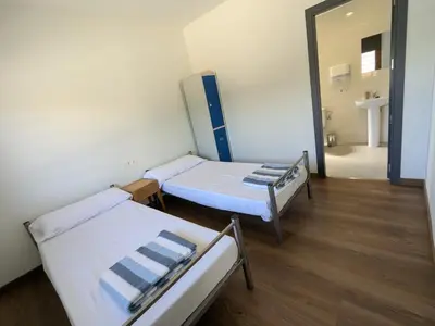 Cama o camas de una habitación en Albergue Municipal Las Escuelas