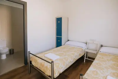 Cama o camas de una habitación en Albergue Municipal Las Escuelas