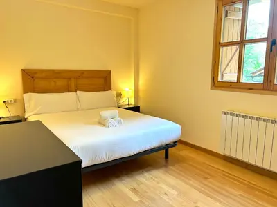 Cama o camas de una habitación en Apartament de muntanya i lluminós by RURAL D'ÀNEU
