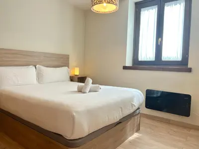 Cama o camas de una habitación en Apartament encantador amb llar de foc by RURAL D'ÀNEU