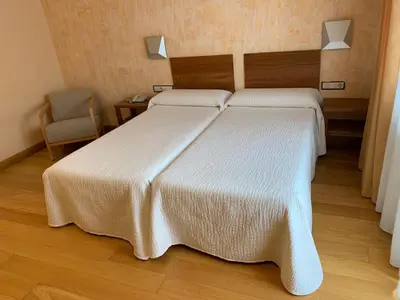 Cama o camas de una habitación en Hotel Los Nogales