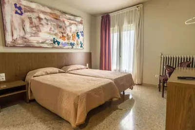 Cama o camas de una habitación en Hostal Sant Miquel