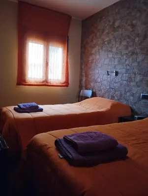 Cama o camas de una habitación en Pensión Matarraña