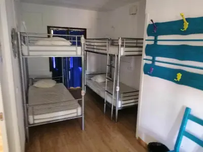Cama o camas de una habitación en Albergue Puente para peregrinos