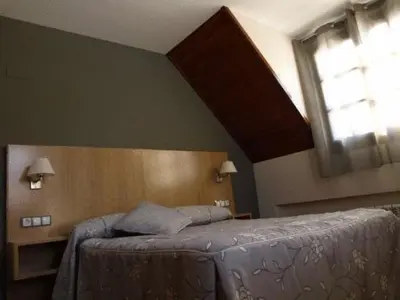 Cama o camas de una habitación en Aparthotel Peña Telera Resort