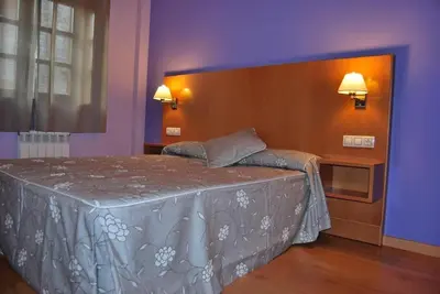 Cama o camas de una habitación en Aparthotel Peña Telera Resort