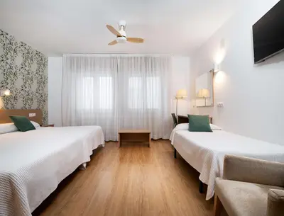 Cama o camas de una habitación en Hotel Mi Casa