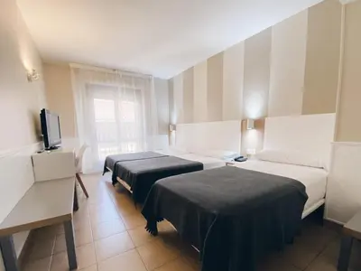 Cama o camas de una habitación en Hotel Rio Arga