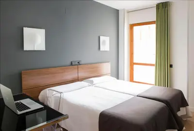 Cama o camas de una habitación en Hospedium Hostal Un Punto Chic