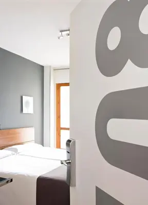 Cama o camas de una habitación en Hospedium Hostal Un Punto Chic