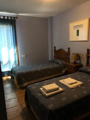 Cama o camas de una habitación en apartamentos turisticos san juan de la peña