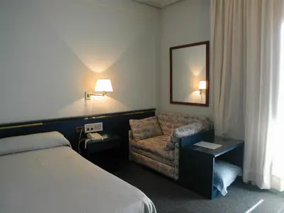 Cama o camas de una habitación en Hotel Rey Sancho Ramírez Somontano SL