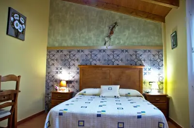 Cama o camas de una habitación en casa oliva la bodegueta