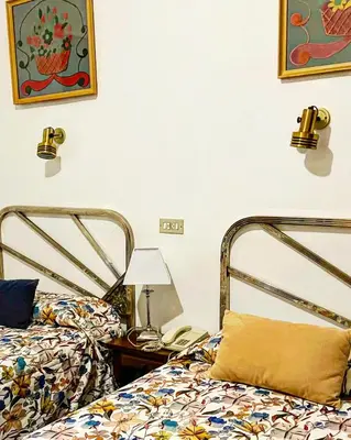 Cama o camas de una habitación en Hostal Pirineos