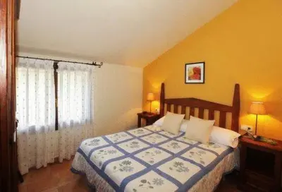 Cama o camas de una habitación en Apartamentos Pirineos Ordesa