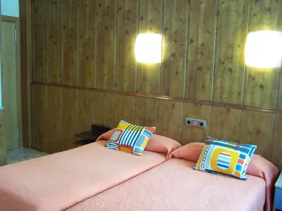 Cama o camas de una habitación en Hostal El Carmen