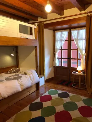 Cama o camas de una habitación en Casa de piedra con encanto en el bonito pueblo de Bagergue
