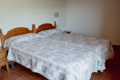 Cama o camas de una habitación en El Portal de la Irene - Apartamentos Rurales