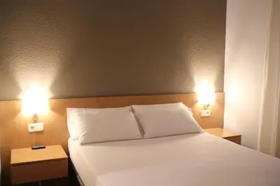 Cama o camas de una habitación en Hostal Abodi