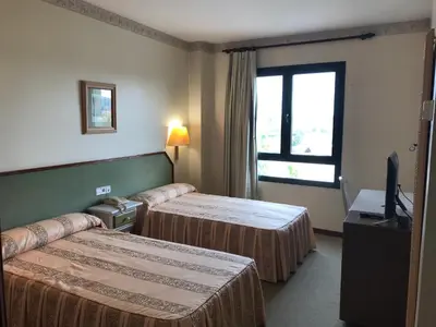 Cama o camas de una habitación en Hotel Magallón