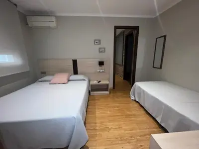 Cama o camas de una habitación en Hostal Crisami