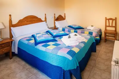 Cama o camas de una habitación en Apartamentos Maribel