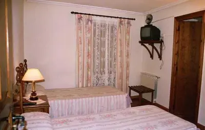 Cama o camas de una habitación en Hostal Las Coronas