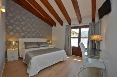 Cama o camas de una habitación en Apartamentos El Palacete de Ainsa