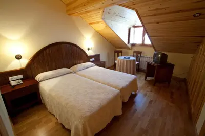 Cama o camas de una habitación en Hotel Estanys Blaus