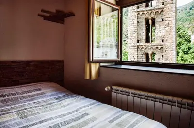 Cama o camas de una habitación en Hostal La Plaça