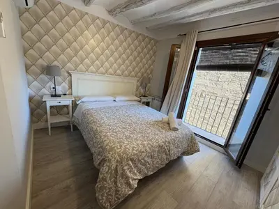 Cama o camas de una habitación en Apartamentos Vino Tinto y Restaurante Tomate Rosa